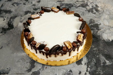 Sponge cake with white milk cream and chocolate decoration