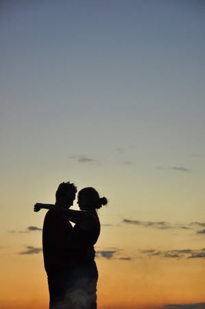 the silhouette of a couple at sunsetの写真素材