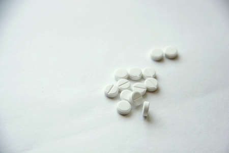 White pills on white backgroundの写真素材