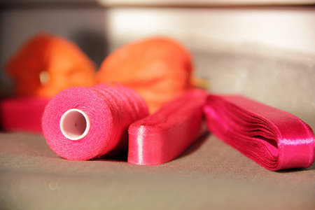 Spools of thread and satin ribbons