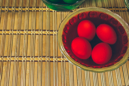 Glass plate with red paint, coloring Easter eggs, copy spaceの写真素材