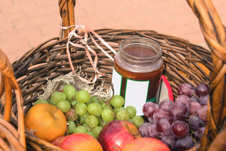 Basket of ripe fruit at the fair. Apples, grapes, honey  and peaches on harvest day