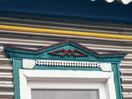 Colored blue-green trim, traditional national window decoration, close-up.の写真素材