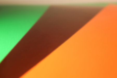 Tricolor bright green, brown and orange colored paper, diagonal stripes. Abstract blurred backgroundの写真素材