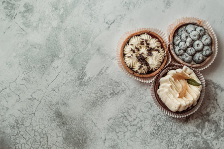 Three cakes with blueberries and sponge cream on a white background. Copy Space, place for descriptionの写真素材