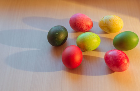Bright colorful Easter eggs and their shadows on the table, spring holidayの写真素材