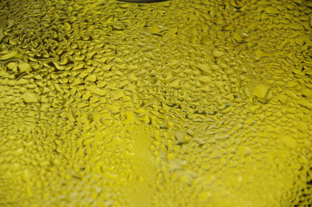 Water condesation drops over a yellow background