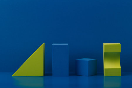 Abstract composition with blue and green geometric figures on blue background with copy spaceの写真素材