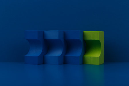 Abstract composition with blue and green figures on blue reflective table against blue backgroundの写真素材