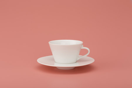 White ceramic coffee cup on beige background with copy spaceの写真素材