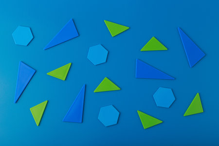 Flat lay with blue and green geometric figures on blue background. Template for advertising bannerの写真素材