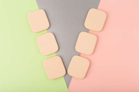 Flat lay with make up sponges against multicolored colored background. Concept of beauty blender variety and visageの写真素材