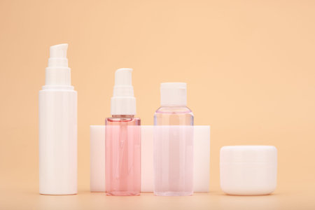 Variety of skin care products against beige background. Beauty products for daily home skin treatment.の写真素材