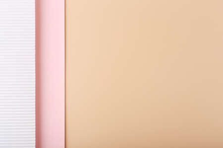 Elegant beige background decorated with white and pink paper. Light pastel beige background with space for text.の写真素材