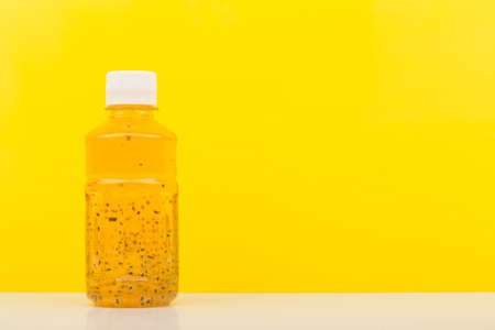 Detox drink or juice with chia seeds on white table against yellow background with copy space. Concept of healthy eating, dieting, weight loss and detoxの写真素材