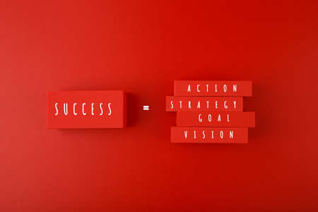 Trendy minimal success formula or business development concept in red colors. Vision, goal, strategy, action written on blocks against red background.の写真素材