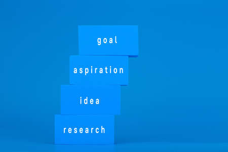 Modern trendy business development or scoring a goal concept. Monochromatic composition with ladder made of blue with written words against blue backgroundの写真素材
