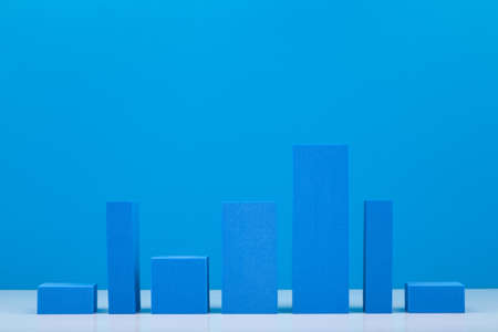 Business concept. Blue performance chart or graph diagram with rise and fall dynamic against blue background. Chart marketing, annual or corporate report, sales or growth evaluation or analytic or profit growingの写真素材