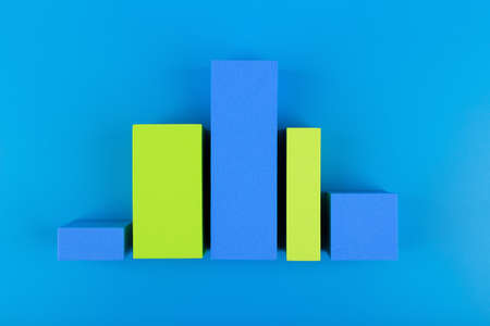 Business concept. Blue and green graph diagram or performance chart with rise and fall dynamic against blue background with copy space. Chart for marketing, annual or corporate report or profit growingの写真素材