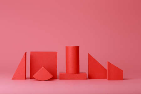 Red geometric figures against dark pink background with copy space. Concept of minimalistic monochromatic backgroundsの写真素材