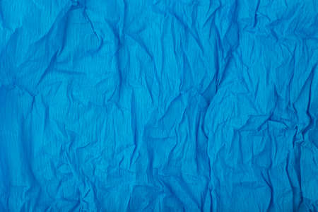 Blue crumpled paper texture background with space for text. Crumpled wrapping paper background. Concept of template for text with high resolutionの写真素材