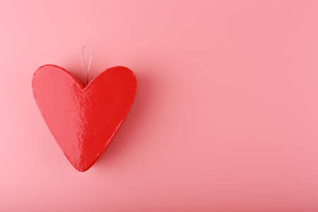 Red heart shaped gift box on bright pink background with copy space. Concept of St. Valentine's day, love and couple's gifts for holidays and anniversary.の写真素材