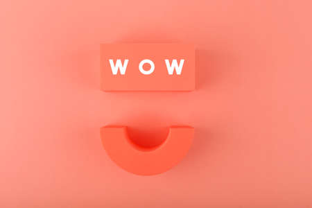 Wow text and smile symbol on orange backgroundの写真素材