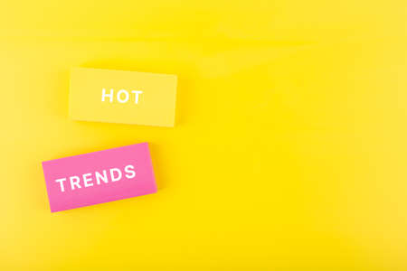 Hot trends written on colorful rectangles on light yellow background with copy spaceの写真素材