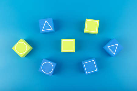 Squid Game Korean movie concept. Circle, triangle and square drawn on green and blue cubes on blue backgroundの写真素材