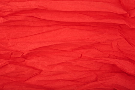 Red crumpled corrugated wrapping paper textured background with space for textの写真素材