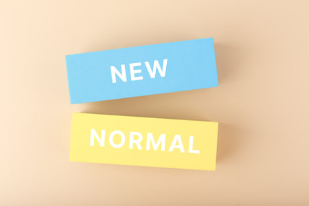New normal minimal concept. Text on yellow and blue rectangles against pastel beige backgroundの写真素材