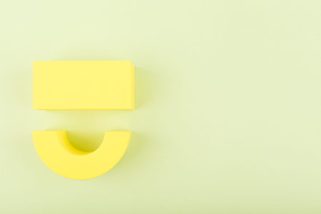 Happy yellow smile symbol on bright pastel green background with copy space. Emoji and positive emotions conceptの写真素材