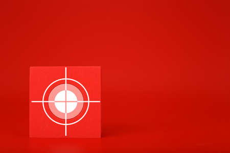 Goal or target symbol on red cube in red background with copy space. Concept of scoring and setting a goalの写真素材