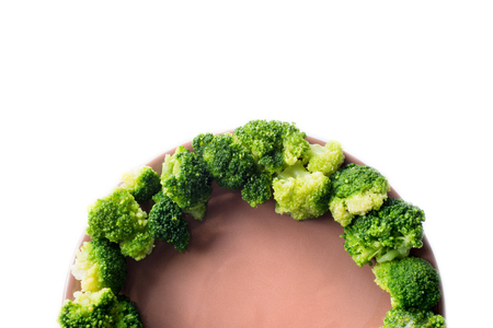 Broccoli on a plate isolated on a white backgroundの写真素材