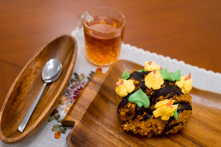 Plate with delicious chocolate cake on wooden trayの写真素材