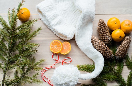 New Year Concept. Christmas decorations from fir-tree branches and the fruits of mandarin orange on wooden backgroundの写真素材