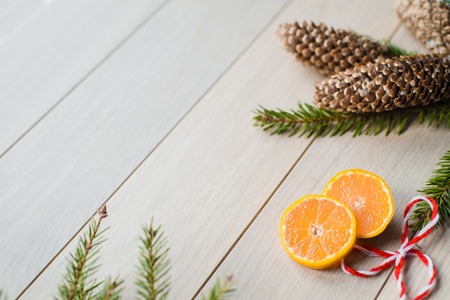 New Year Concept. Christmas decorations from fir-tree branches and the fruits of mandarin orange on wooden background. Card. A place for your recording.の写真素材