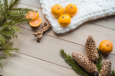New Year Concept. Christmas decorations from fir-tree branches and the fruits of mandarin orange on wooden backgroundの写真素材