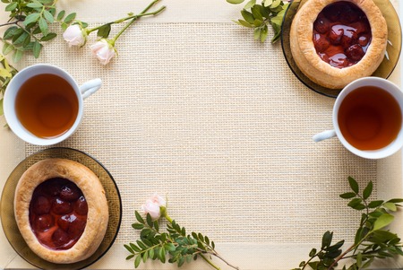 Morning tea with baked goods, rose flowers on the table. Cake with strawberries. On an rustic napkinの写真素材