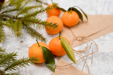 Christmas mandarins on a linen napkin. Textured white backgroundの写真素材