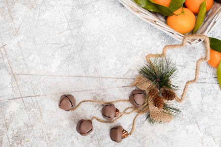 Christmas mandarins in the basket. On a white textured background. Place for your inscriptionの写真素材