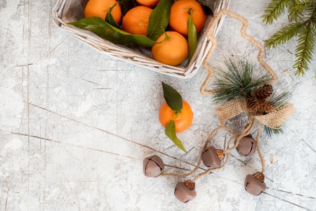 Christmas mandarins in the basket. On a white textured background. Place for your inscriptionの写真素材