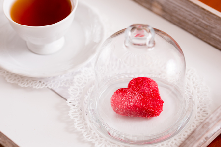Tea cup with heart shaped biscuits. Sugar red biscuits. Gingerbread spices with spices in the form of heartの写真素材