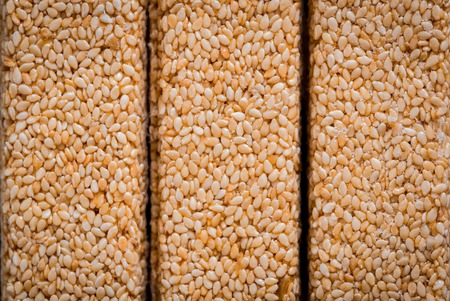 Kozinaki with seeds, nuts, sesame and honey. On a dark wooden backgroundの写真素材