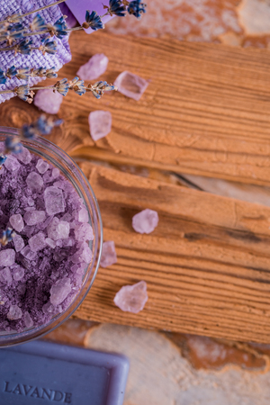 spa massage setting, lavender product, oil on wooden background, Soap lavender flavored salt violet color, Copy space, top viewの写真素材