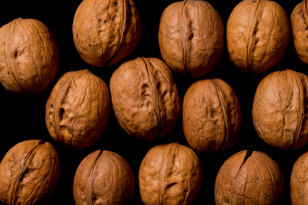 Walnuts isolated on black background, walnut as background on black backgroundの写真素材