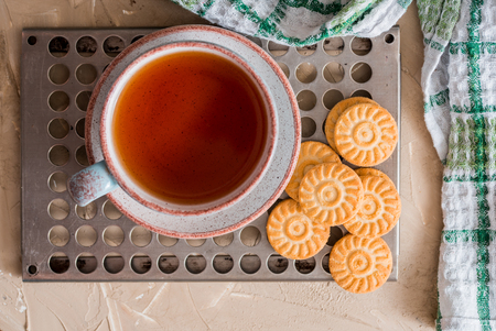 Green herbal tea is served on a metal vintage antique retro tray with homemade cakes - round biscuit biscuits. on a wooden backgroundの写真素材