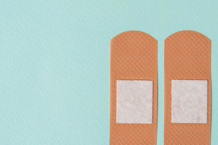 two medical plaster on a blue background Copy space, top view