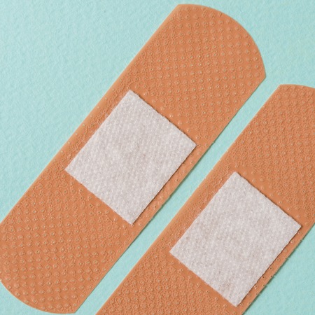 two medical plaster on a blue background top view closeup macroの写真素材