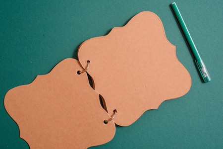 School supplies, notebook, pen and pencil on a green background. copy spaceの写真素材